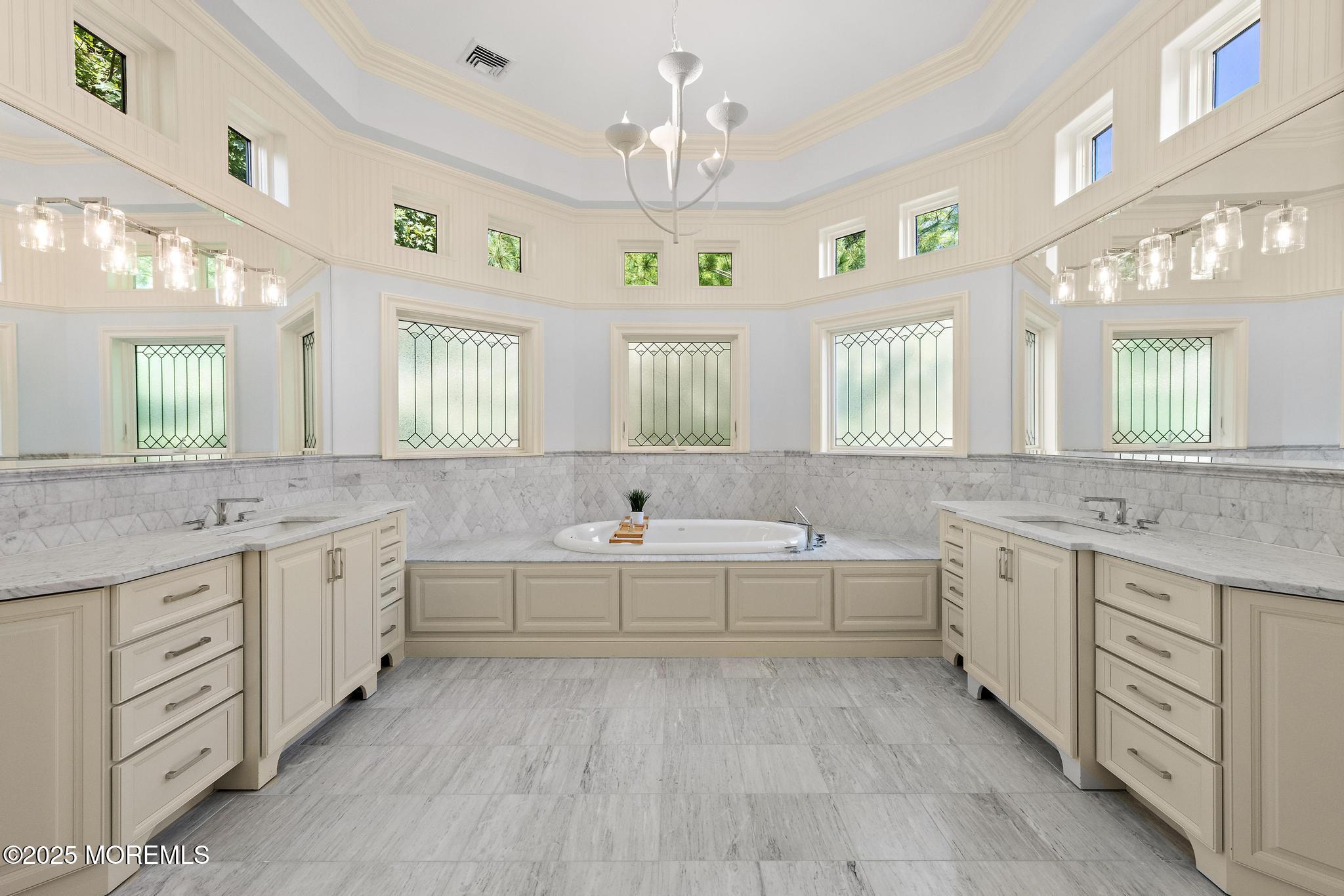 129 Ave Of Two Rivers Rumson, NJ 07760 - Photo 34 of 55 a spacious bathroom with a granite countertop double vanity sink a bathtub and a window