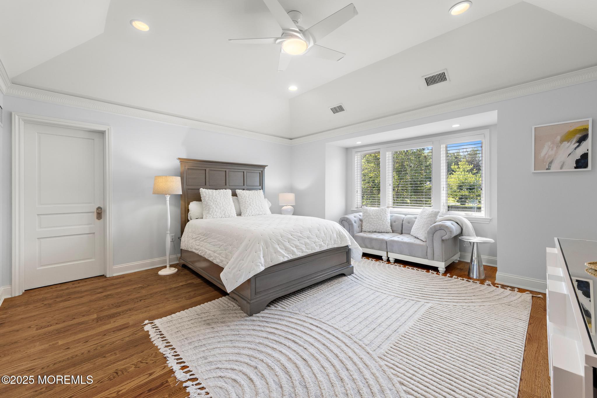 129 Ave Of Two Rivers Rumson, NJ 07760 - Photo 40 of 55 a bedroom with a bed couch and wooden floor