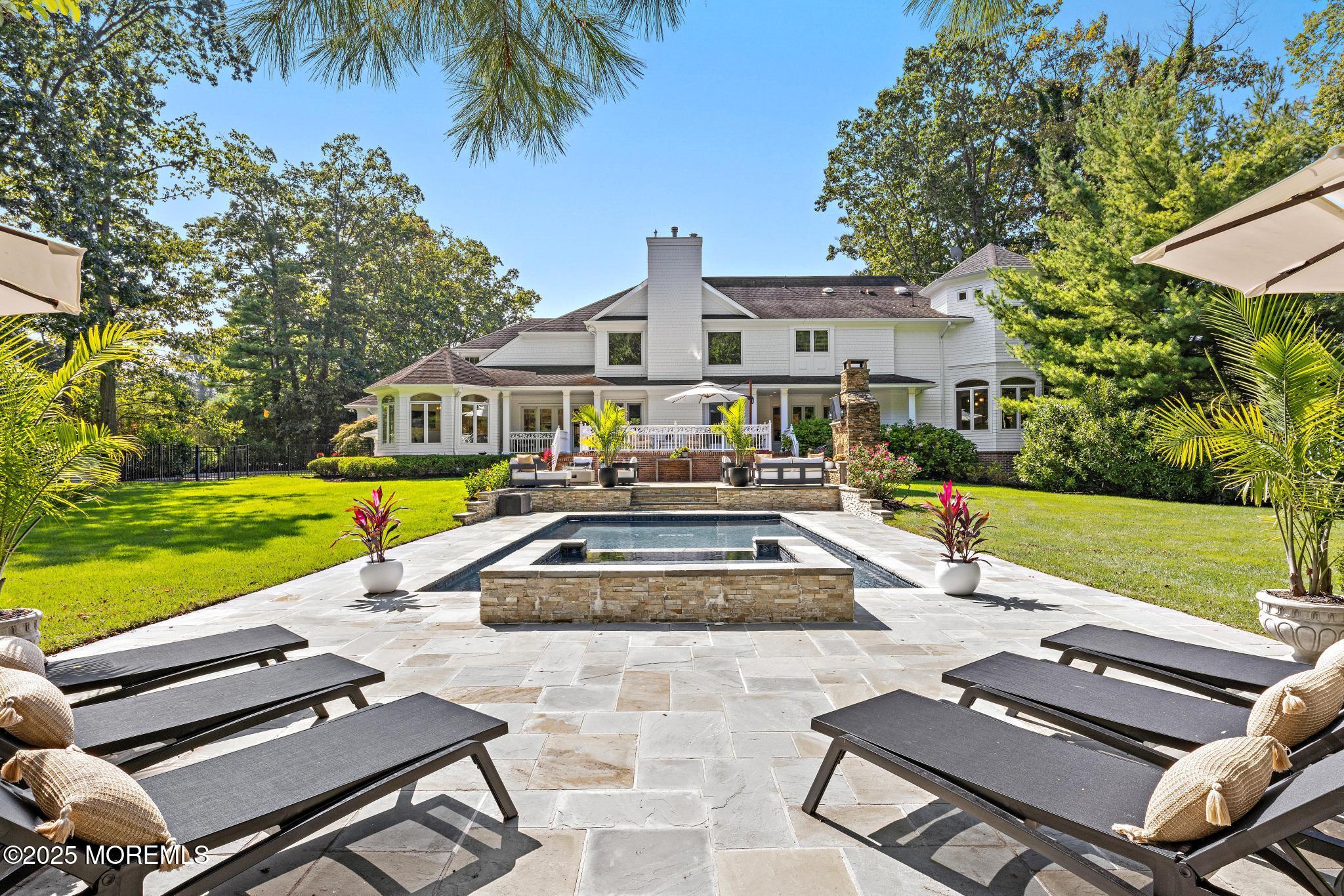 129 Ave Of Two Rivers Rumson, NJ 07760 - Photo 47 of 55 a view of a house with swimming pool and a yard