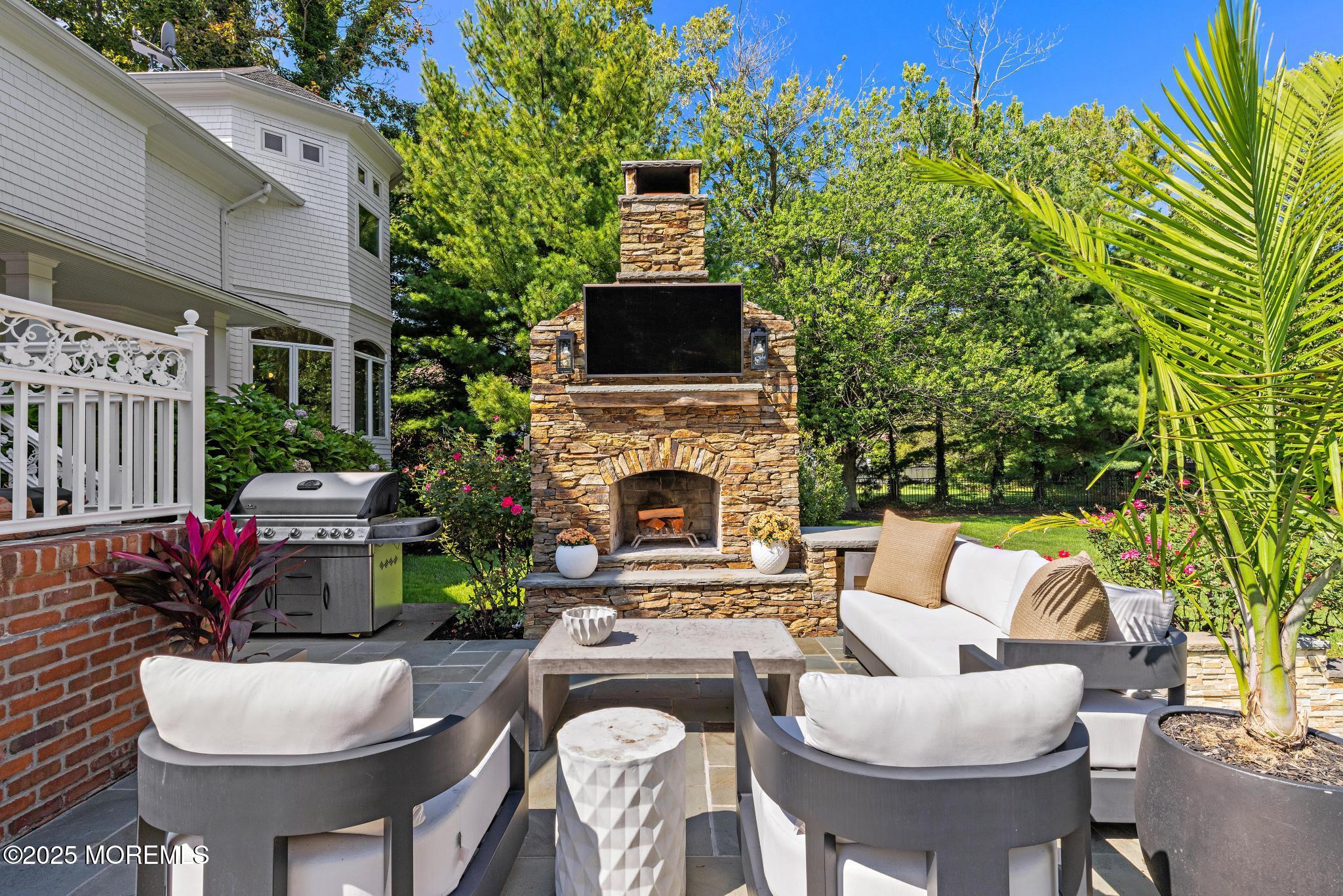 129 Ave Of Two Rivers Rumson, NJ 07760 - Photo 50 of 55 a view of a patio with couches table and chairs with potted plants