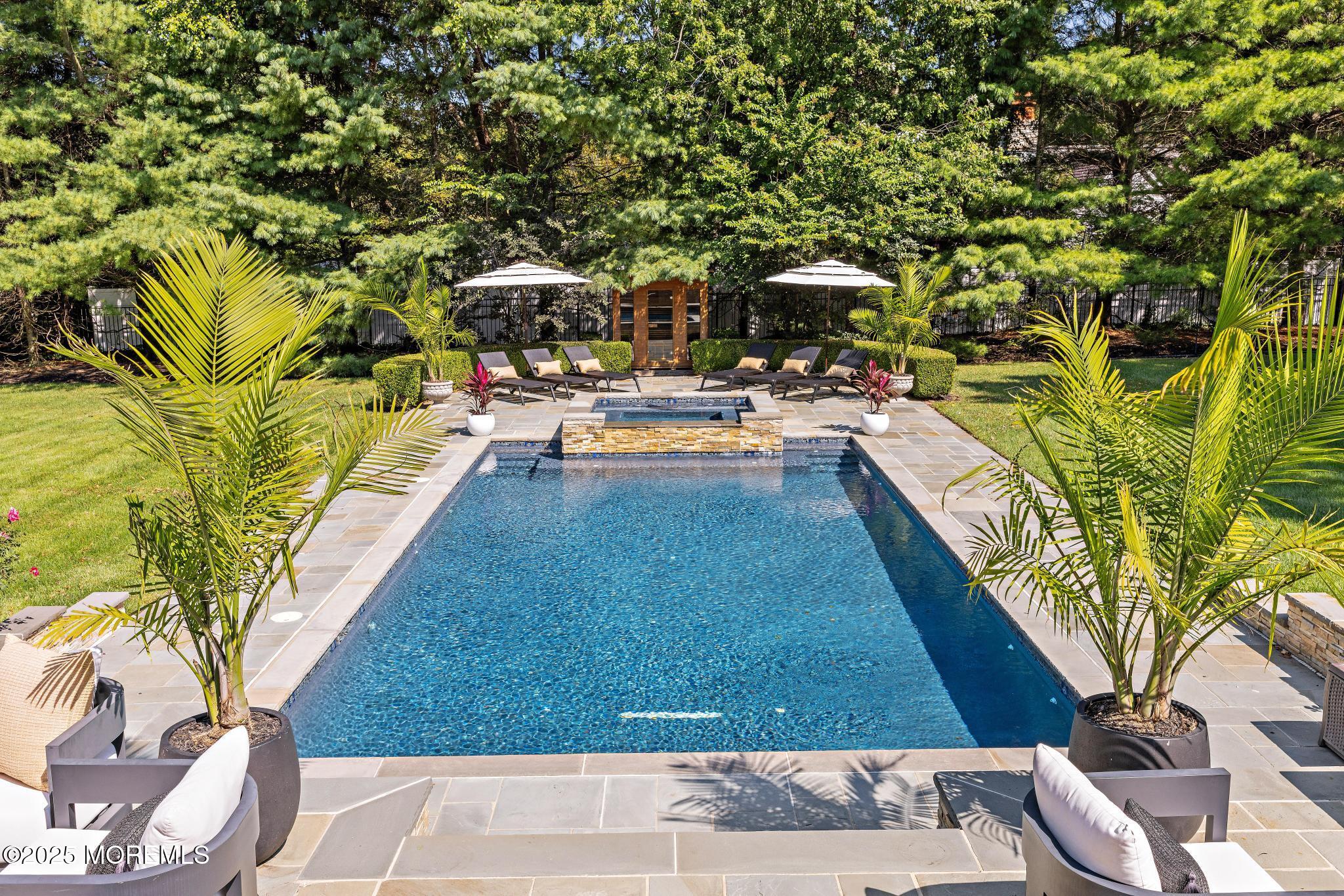 129 Ave Of Two Rivers Rumson, NJ 07760 - Photo 51 of 55 a view of swimming pool with outdoor seating and plants