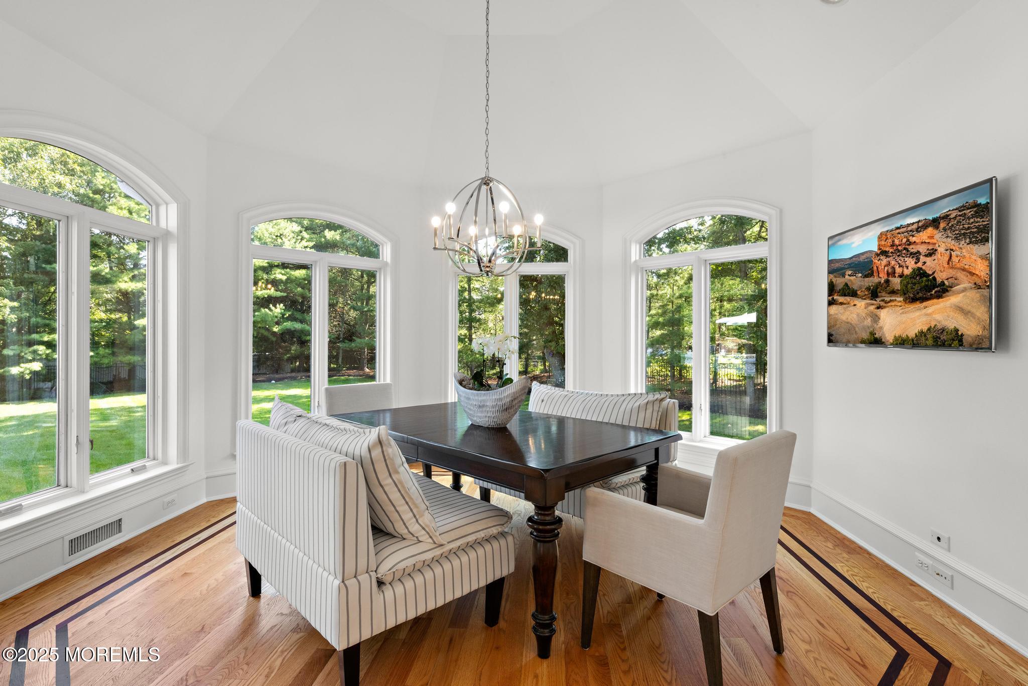 129 Ave Of Two Rivers Rumson, NJ 07760 - Photo 8 of 55 a dining room with furniture a chandelier and wooden floor