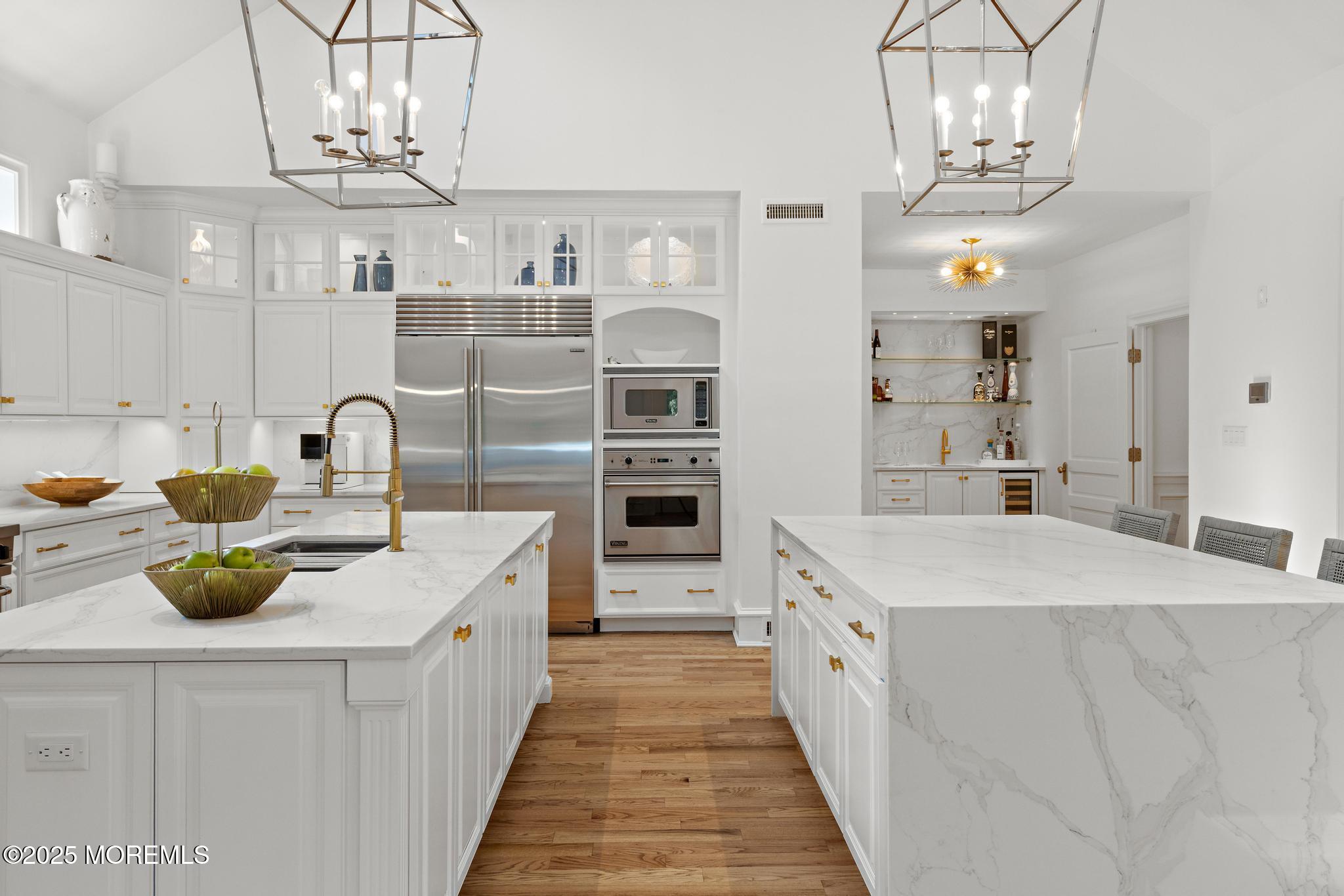 129 Ave Of Two Rivers Rumson, NJ 07760 - Photo 9 of 55 a kitchen with stainless steel appliances a sink stove and cabinets
