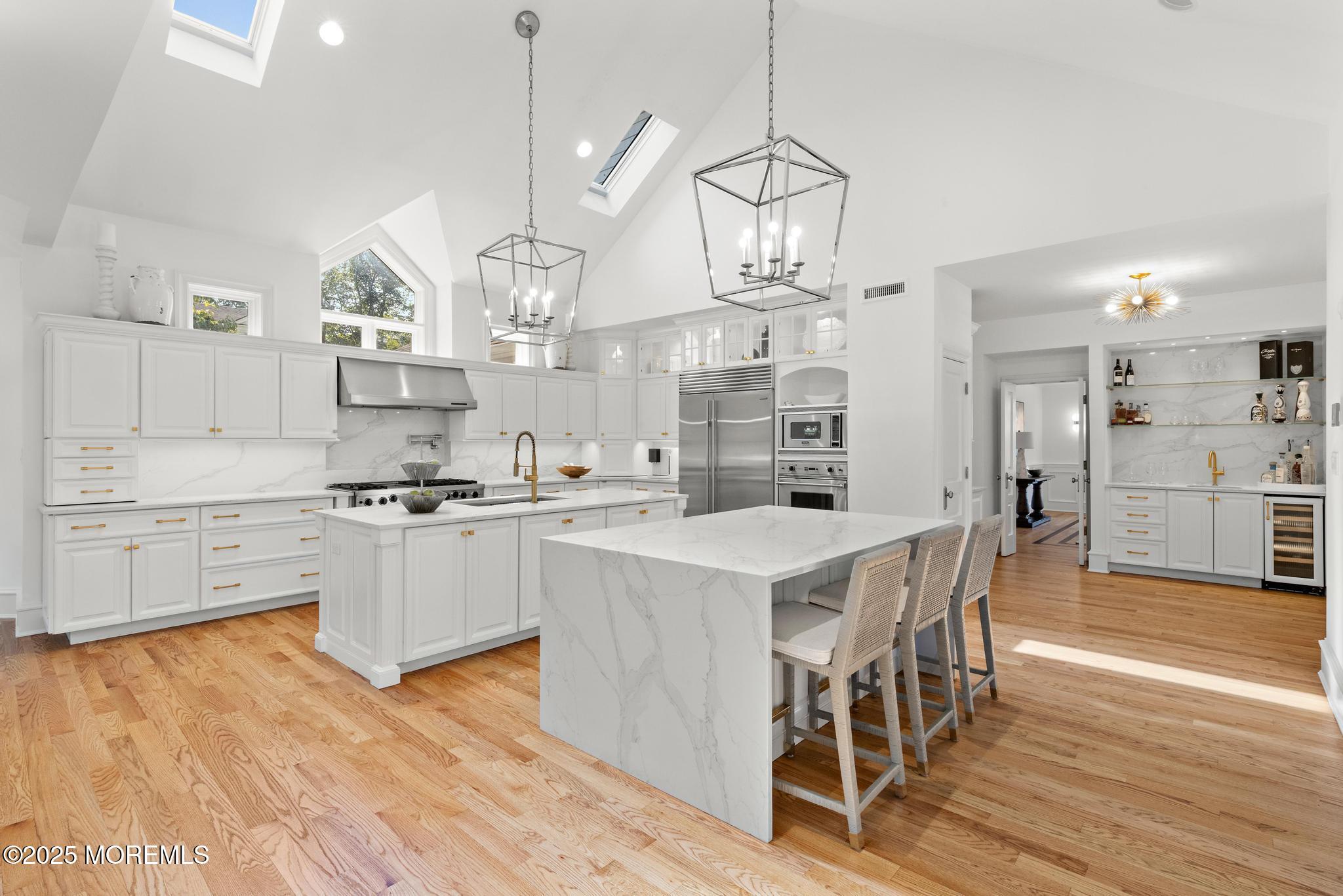 129 Ave Of Two Rivers Rumson, NJ 07760 - Photo 10 of 55 a large kitchen with kitchen island a large island a stove a table and chairs in it