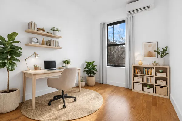 a spacious bedroom with a bed and window