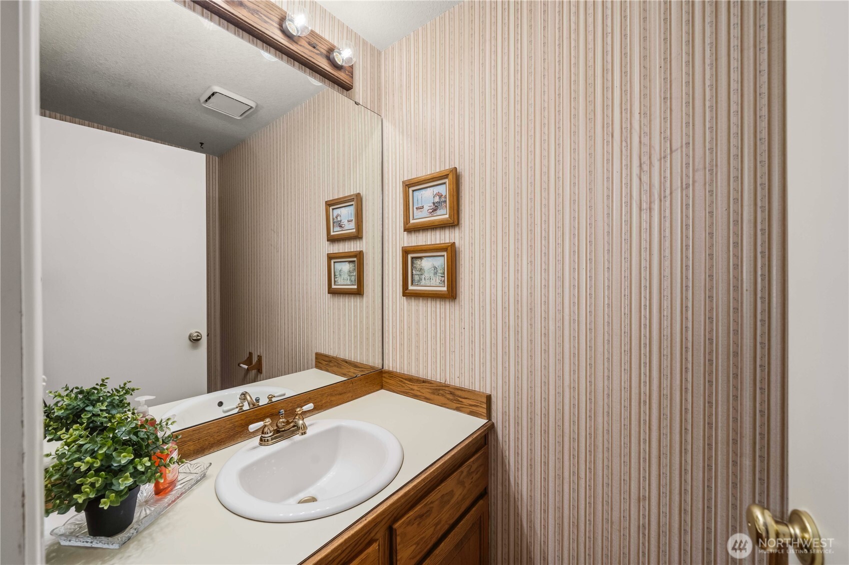 3811 South 255th Place Kent, WA 98032 - Photo 11 of 30 a bathroom with a sink and a mirror