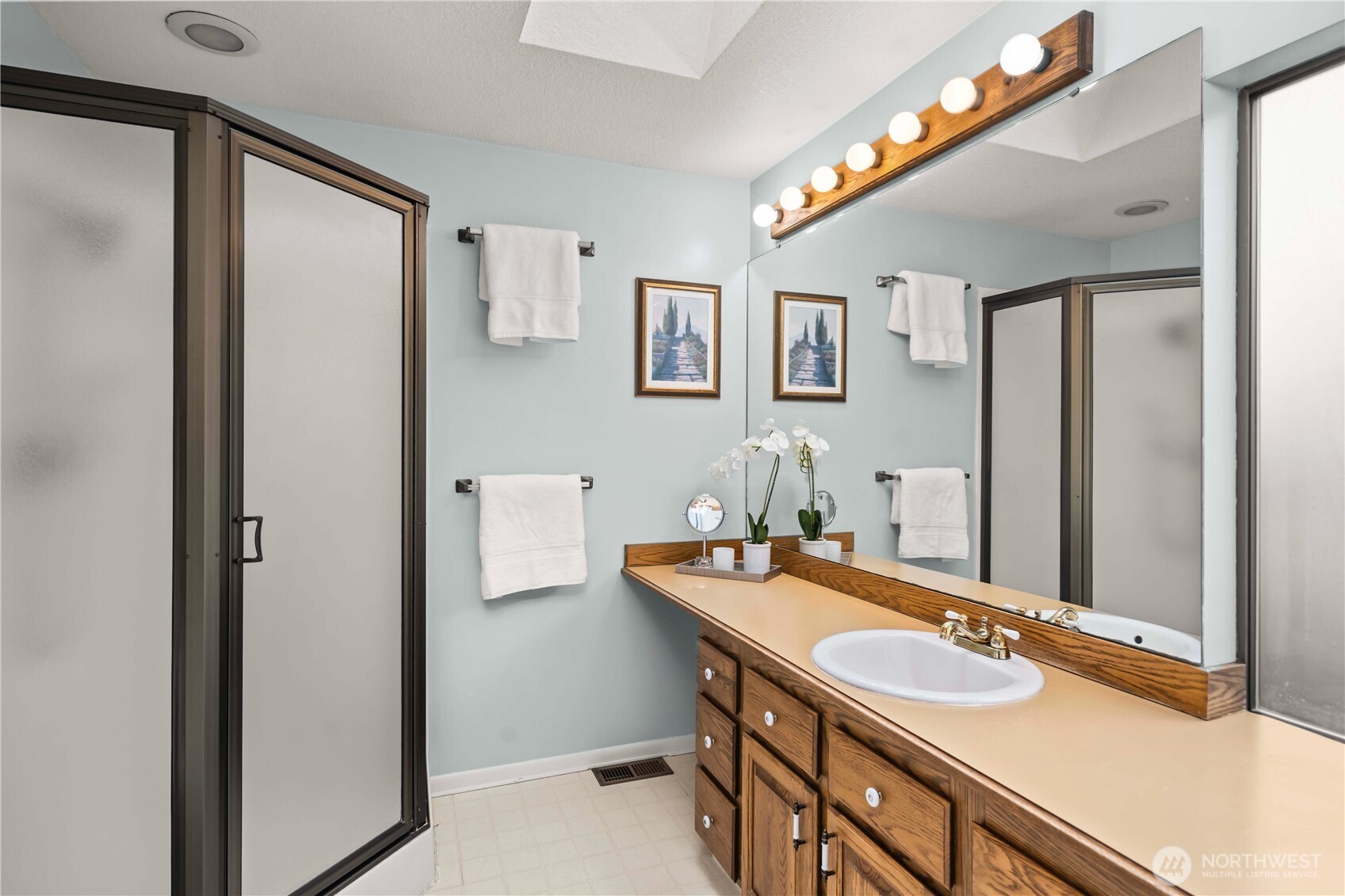 3811 South 255th Place Kent, WA 98032 - Photo 17 of 30 a bathroom with a sink and a mirror