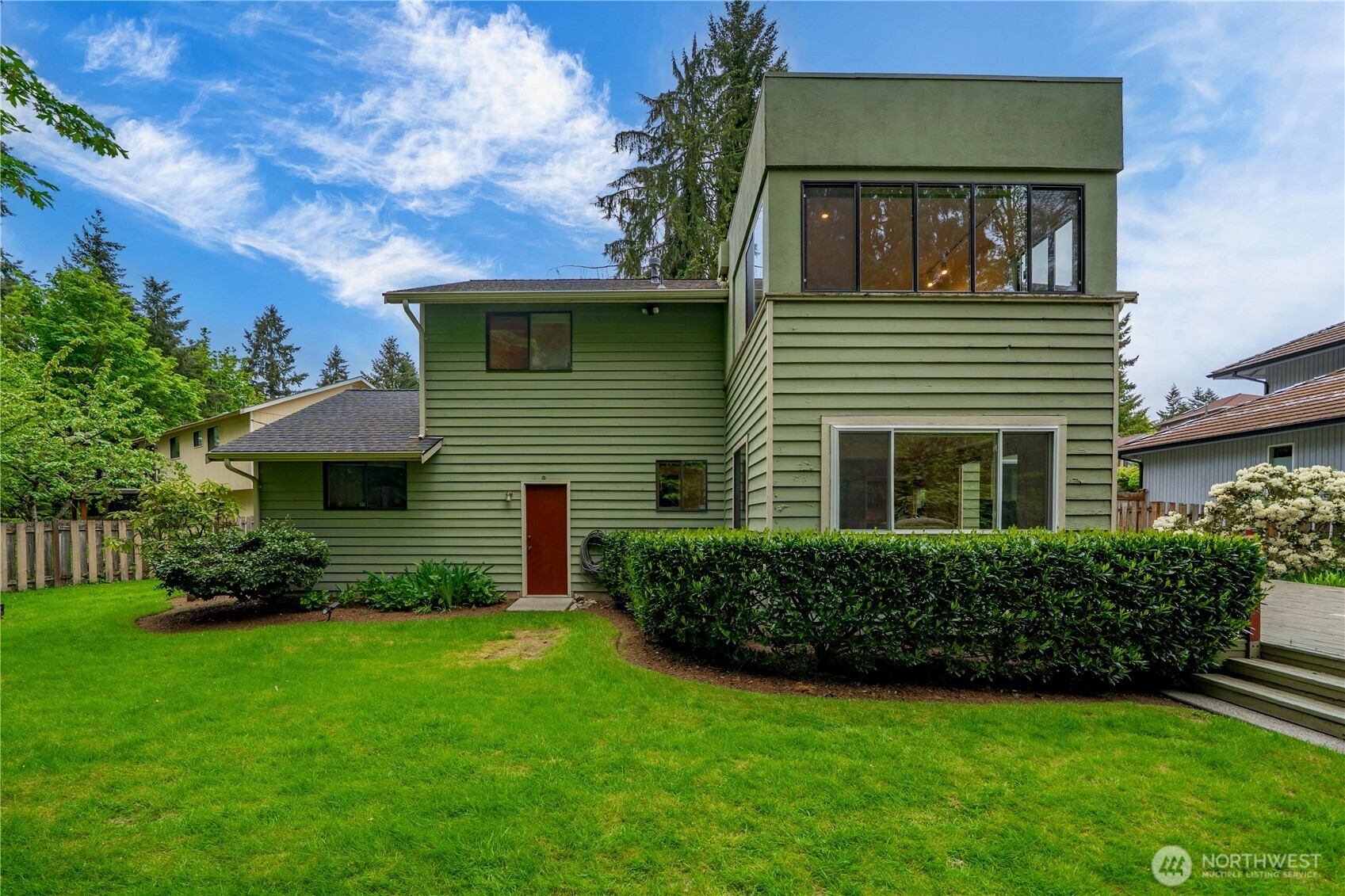 3811 South 255th Place Kent, WA 98032 - Photo 24 of 30 a front view of a house with a yard and trees