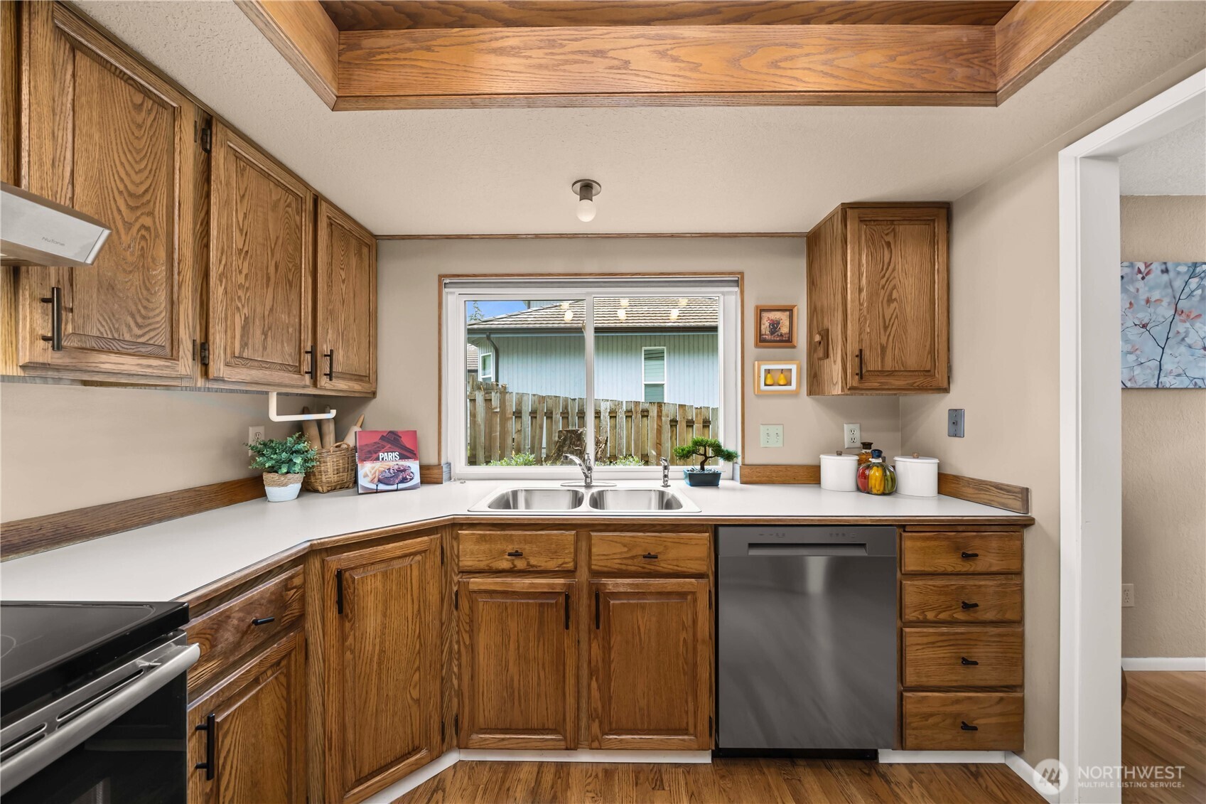 3811 South 255th Place Kent, WA 98032 - Photo 4 of 30 a kitchen with a sink a cabinets and window