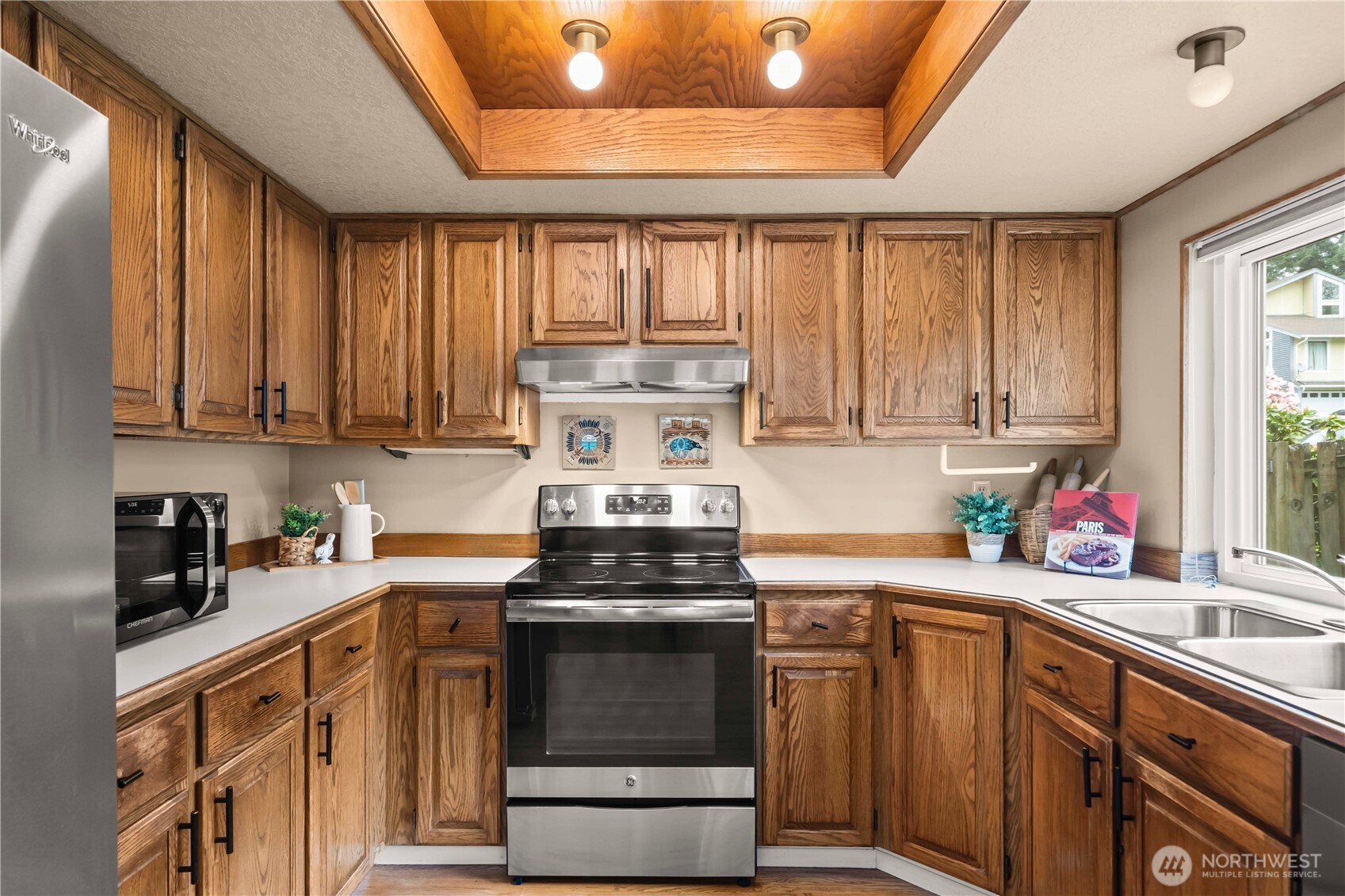 3811 South 255th Place Kent, WA 98032 - Photo 5 of 30 a kitchen with a sink a stove cabinets and a window