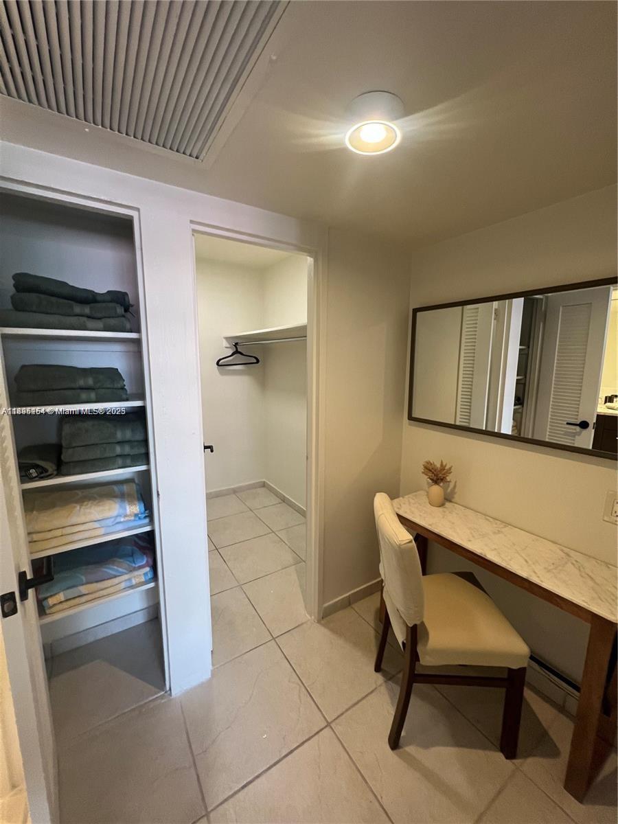 5161 Collins Avenue, Unit 1211 Miami Beach, FL 33140 - Photo 12 of 29 a room with table chairs and a potted plant