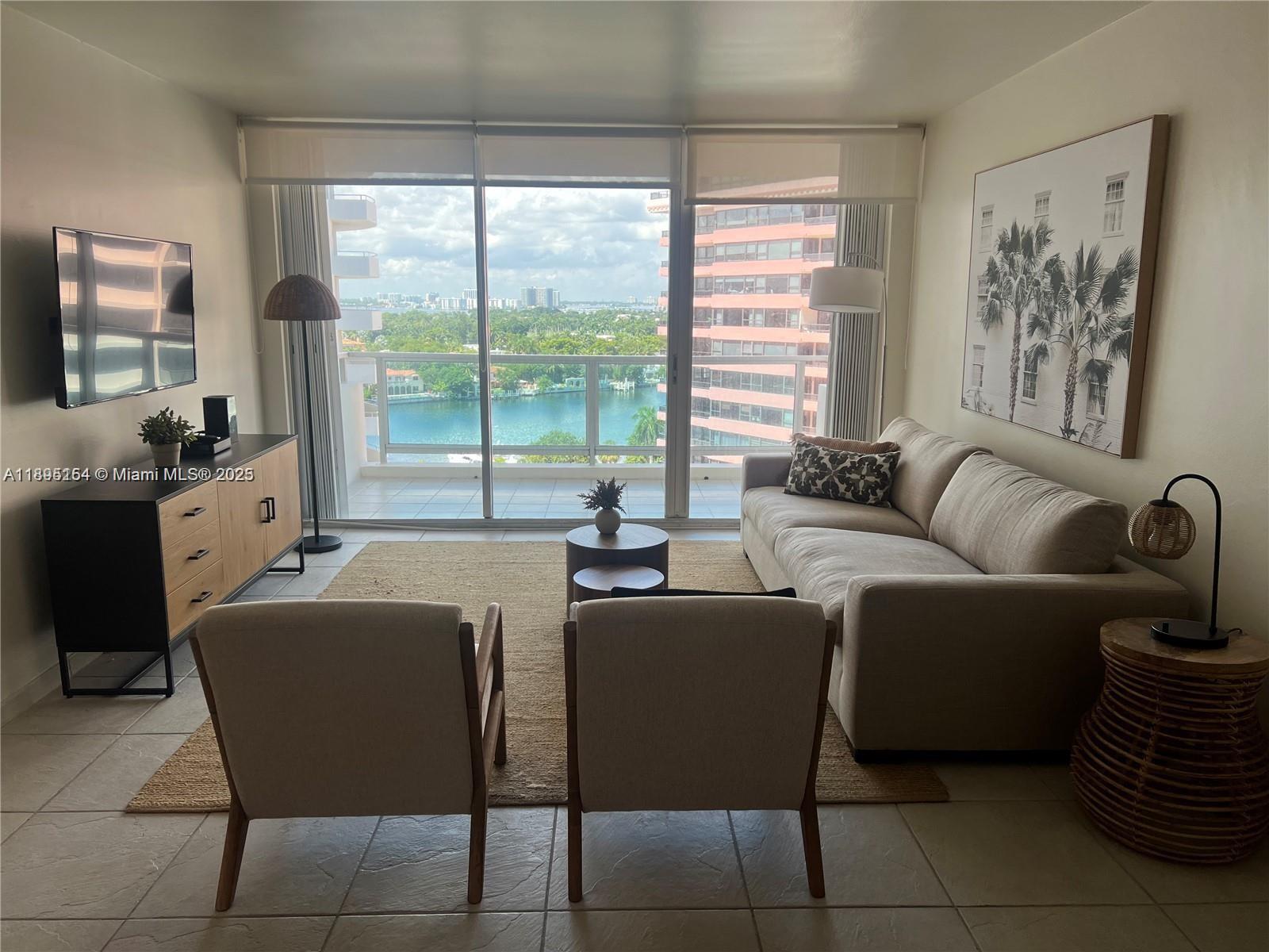 5161 Collins Avenue, Unit 1211 Miami Beach, FL 33140 - Photo 4 of 29 a living room with furniture and a floor to ceiling window