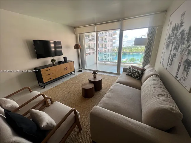 a kitchen with stainless steel appliances kitchen island granite countertop a refrigerator and a stove top oven