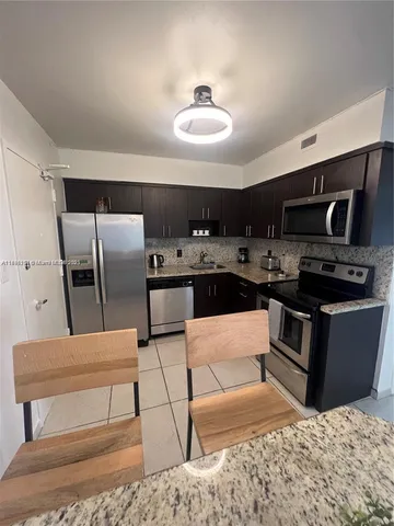 a balcony with table and chairs