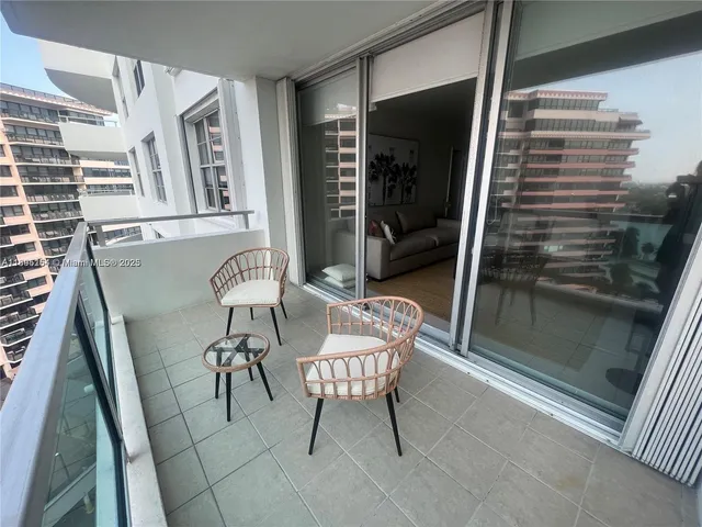 a chairs and a table in a balcony