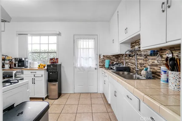 a kitchen with refrigerator and cabinets