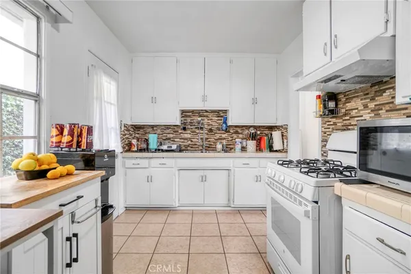 a kitchen with stainless steel appliances a stove a sink and a refrigerator
