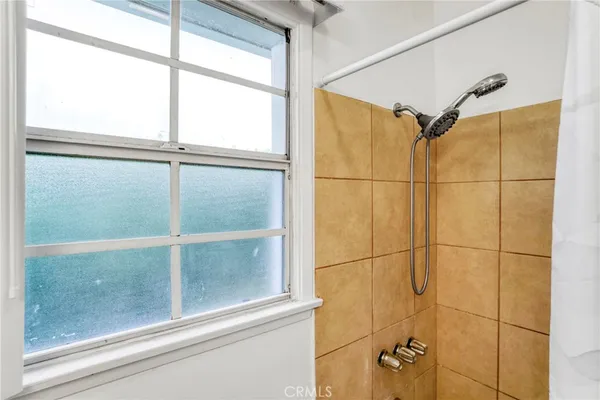 a bathroom with a glass shower door