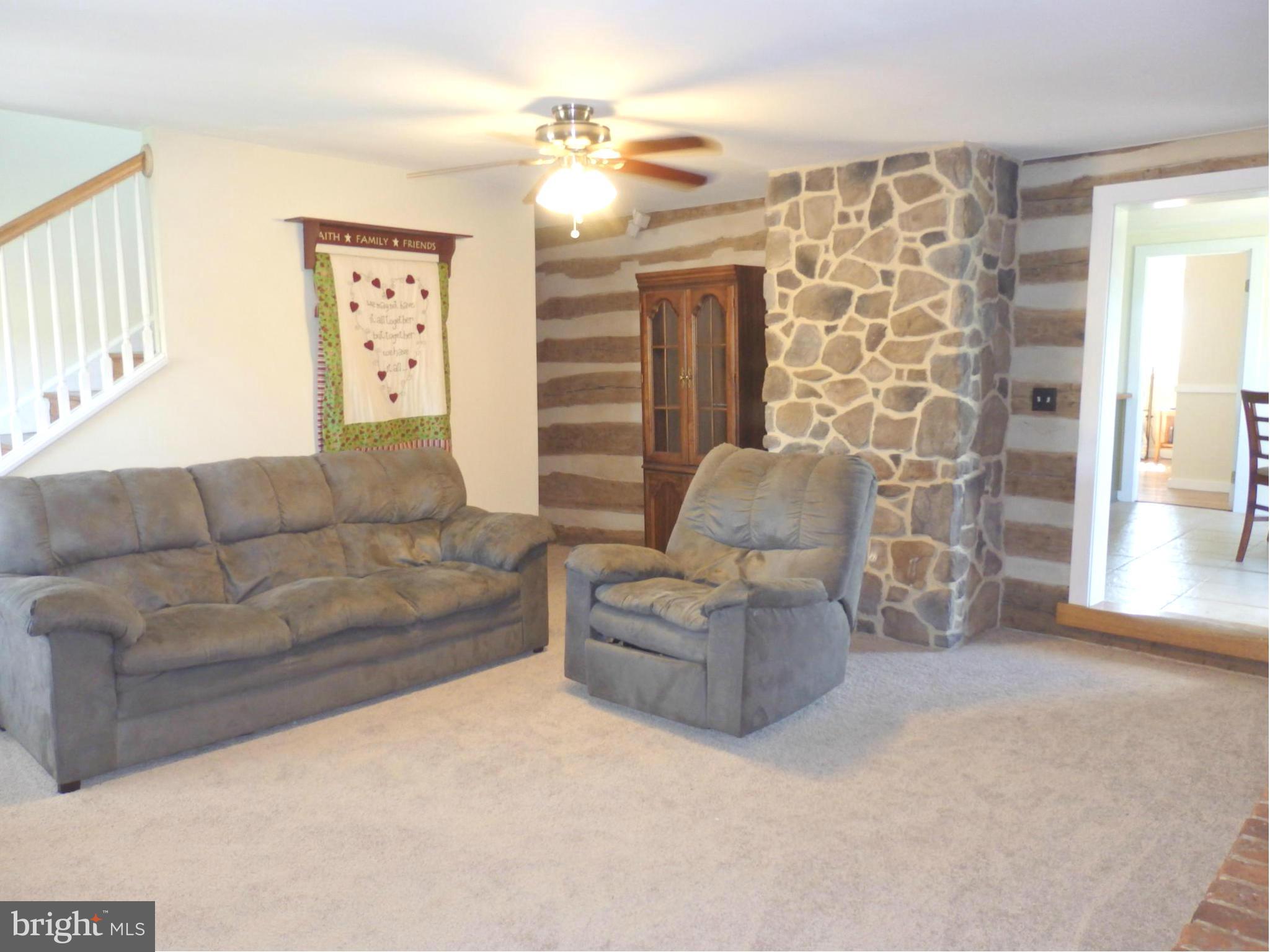 10529 White Hall Road Hagerstown, MD 21740 - Photo 4 of 29 Living Room boasts stone and log walls