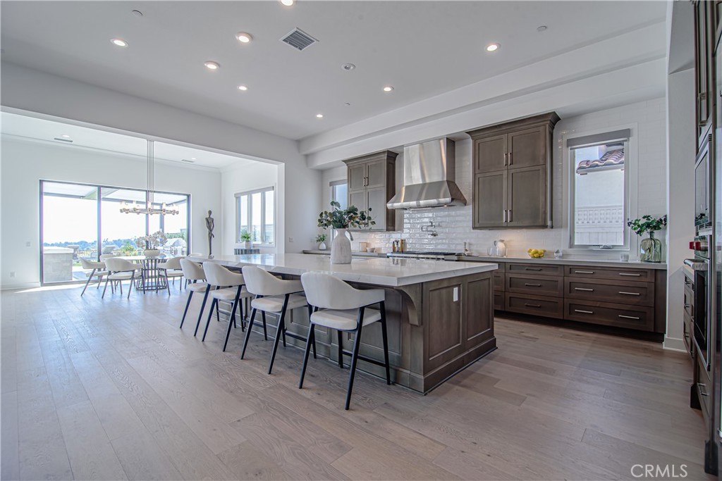 73 Chandler Ranch Road Rolling Hills Estates, CA 90274 - Photo 2 of 25 a kitchen with a table chairs sink and cabinets