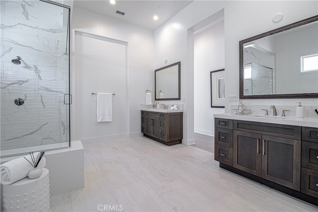 73 Chandler Ranch Road Rolling Hills Estates, CA 90274 - Photo 9 of 25 a spacious bathroom with a double vanity sink a large mirror and shower