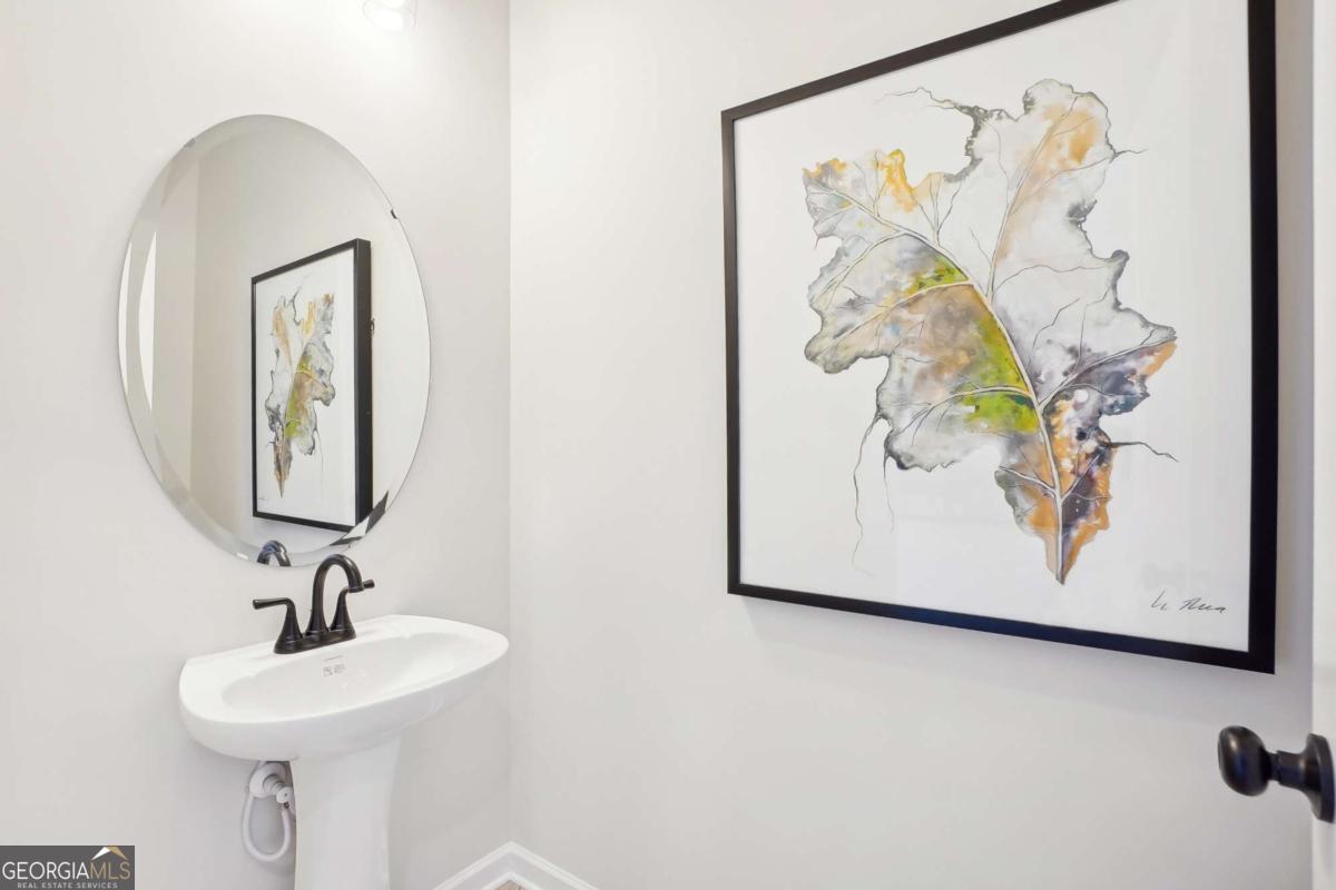 1441 Trellis Court, Unit (LOT 7) Hampton, GA 30228 - Photo 16 of 31 a bathroom with a sink and a mirror