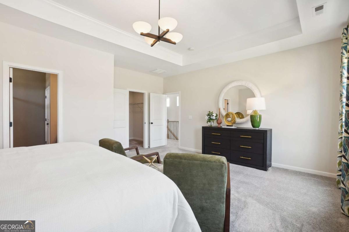 1441 Trellis Court, Unit (LOT 7) Hampton, GA 30228 - Photo 22 of 31 a bedroom with a bed and a dresser