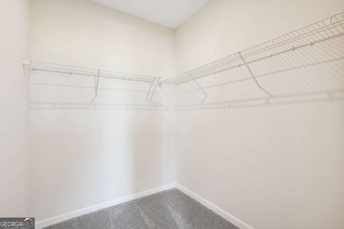 1441 Trellis Court, Unit (LOT 7) Hampton, GA 30228 - Photo 23 of 31 a view of a room with racks on the wall