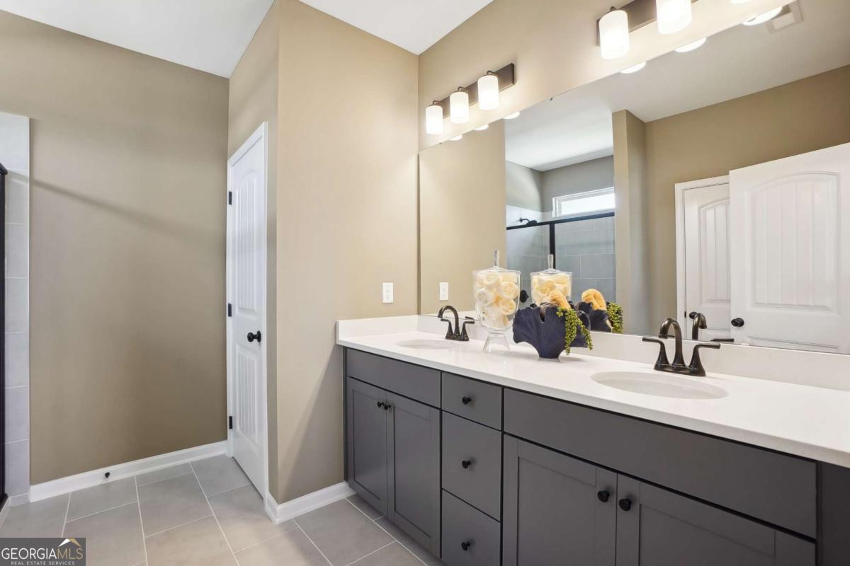 1441 Trellis Court, Unit (LOT 7) Hampton, GA 30228 - Photo 24 of 31 a bathroom with a double vanity sink mirror and next to a window