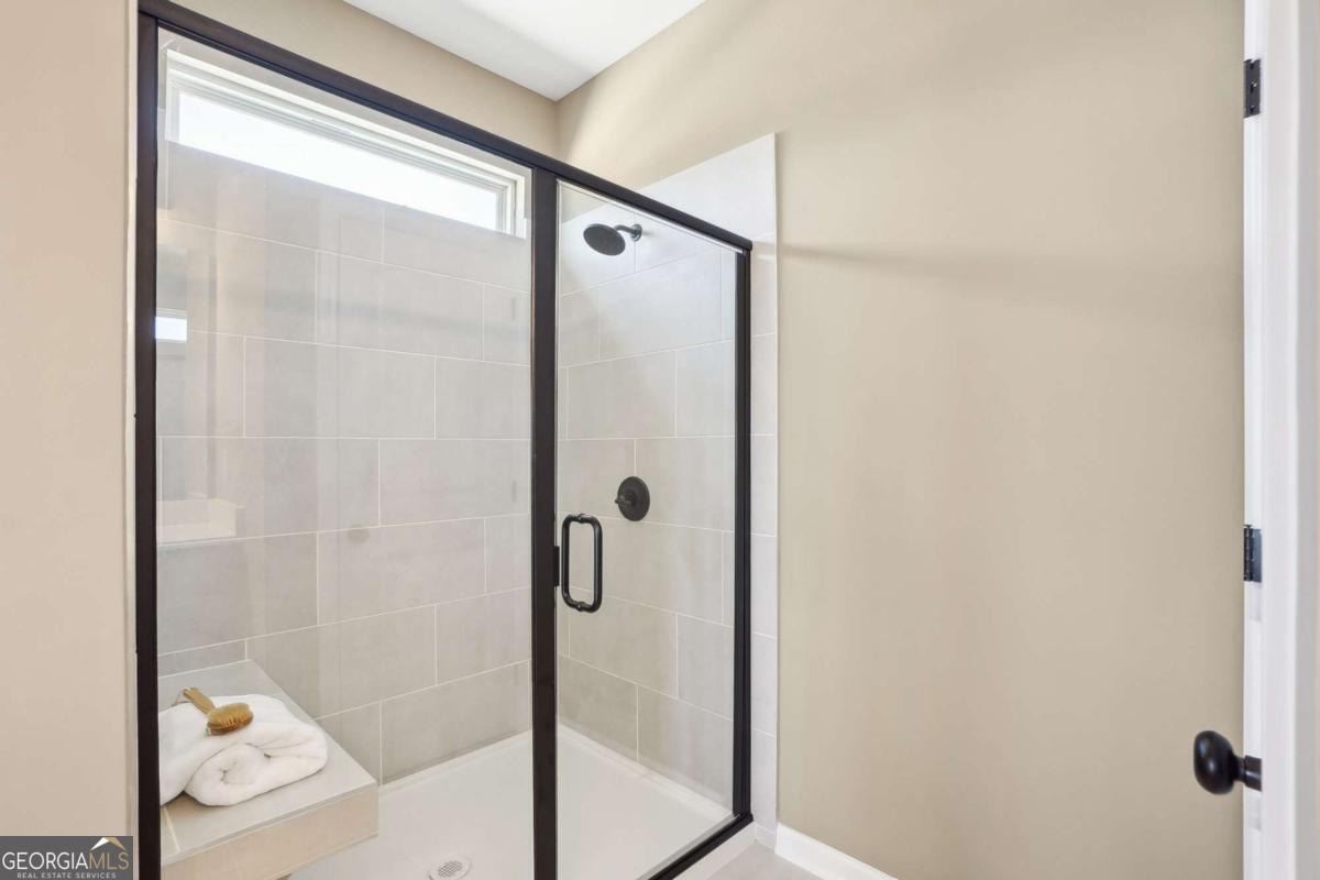 1441 Trellis Court, Unit (LOT 7) Hampton, GA 30228 - Photo 25 of 31 a bathroom with a glass shower door