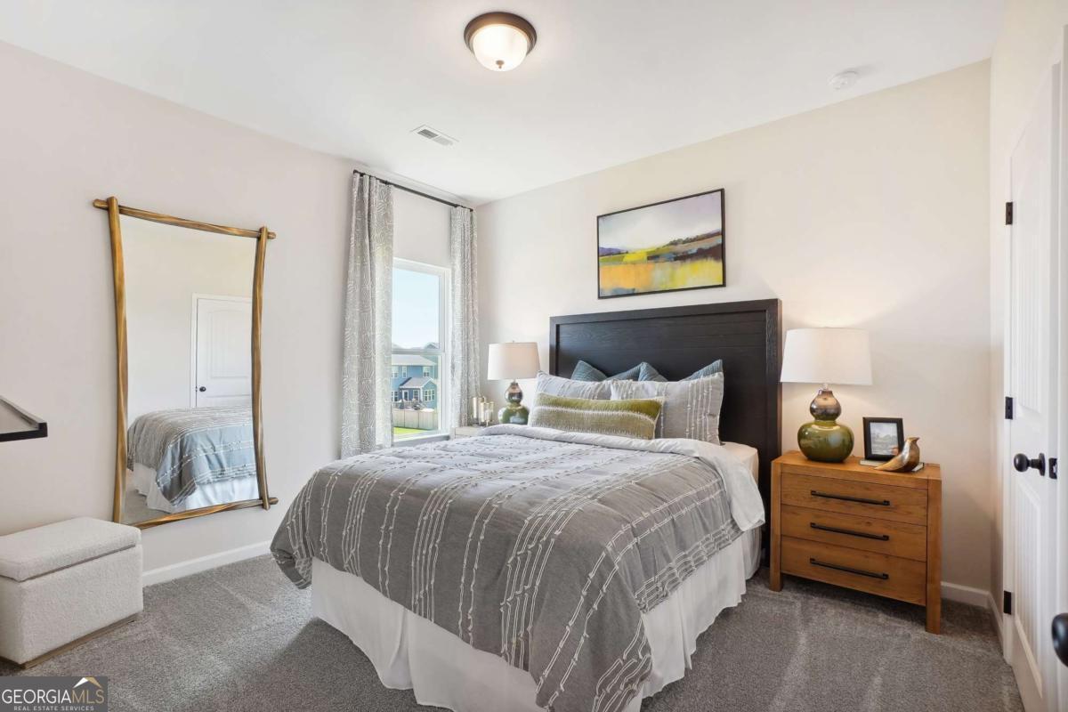 1441 Trellis Court, Unit (LOT 7) Hampton, GA 30228 - Photo 29 of 31 a bedroom with a bed and a couch