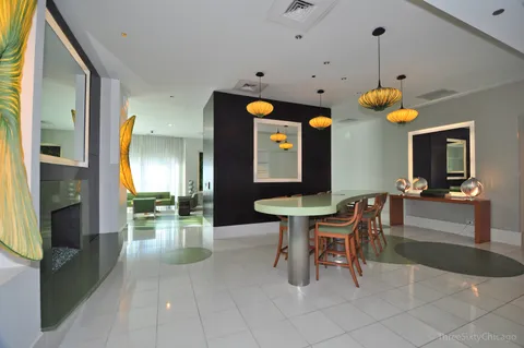 a dining room with a table chairs and a chandelier