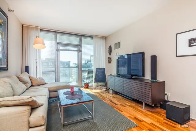 a living room with furniture and a floor to ceiling window
