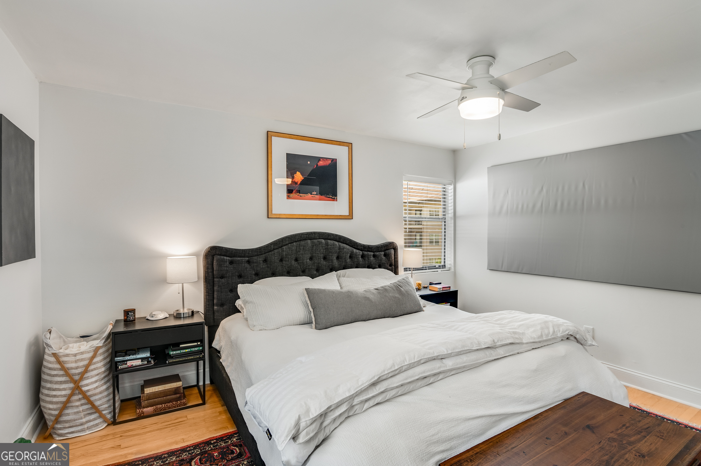 96 Ardmore Place Northwest, Unit 3 Atlanta, GA 30309 - Photo 24 of 24 a bedroom with a bed and a chandelier