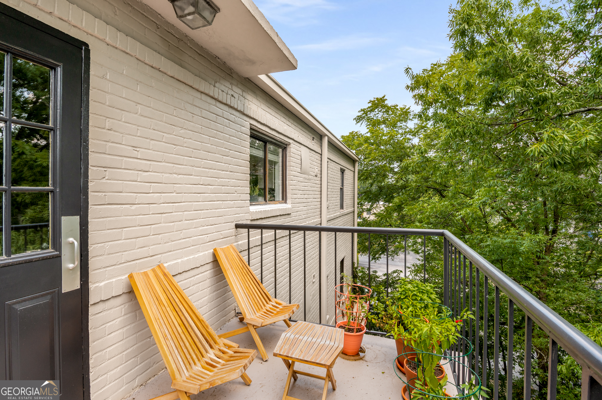 96 Ardmore Place Northwest, Unit 3 Atlanta, GA 30309 - Photo 17 of 24 a balcony with wooden floor and outdoor seating
