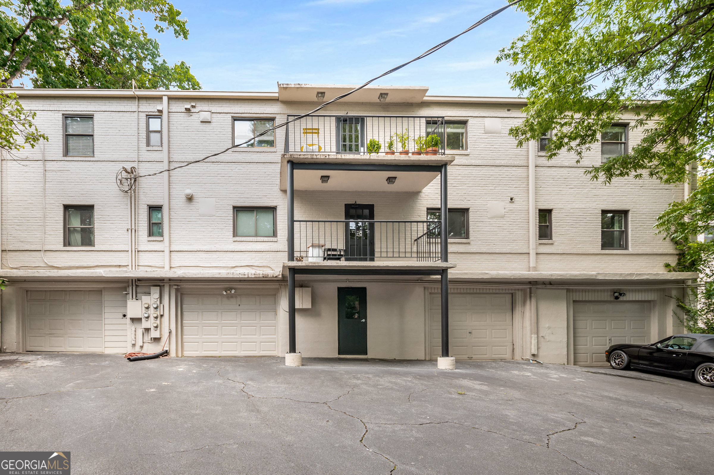 96 Ardmore Place Northwest, Unit 3 Atlanta, GA 30309 - Photo 19 of 24 a view of a building with a lot of windows and a tree