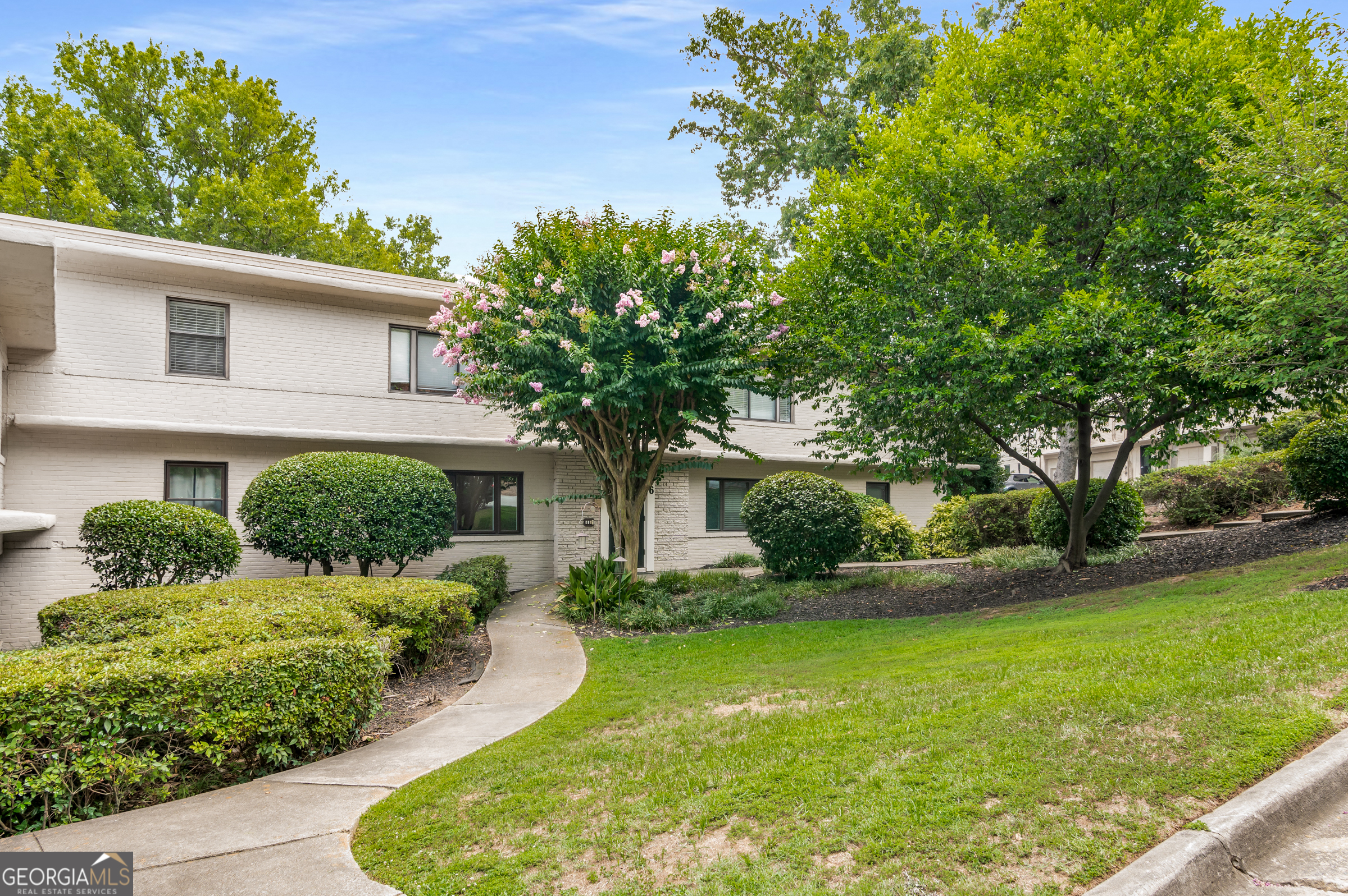 96 Ardmore Place Northwest, Unit 3 Atlanta, GA 30309 - Photo 2 of 24 a front view of a house with garden