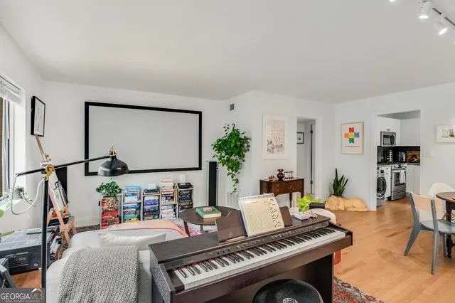 a living room with furniture a rug and a flat screen tv