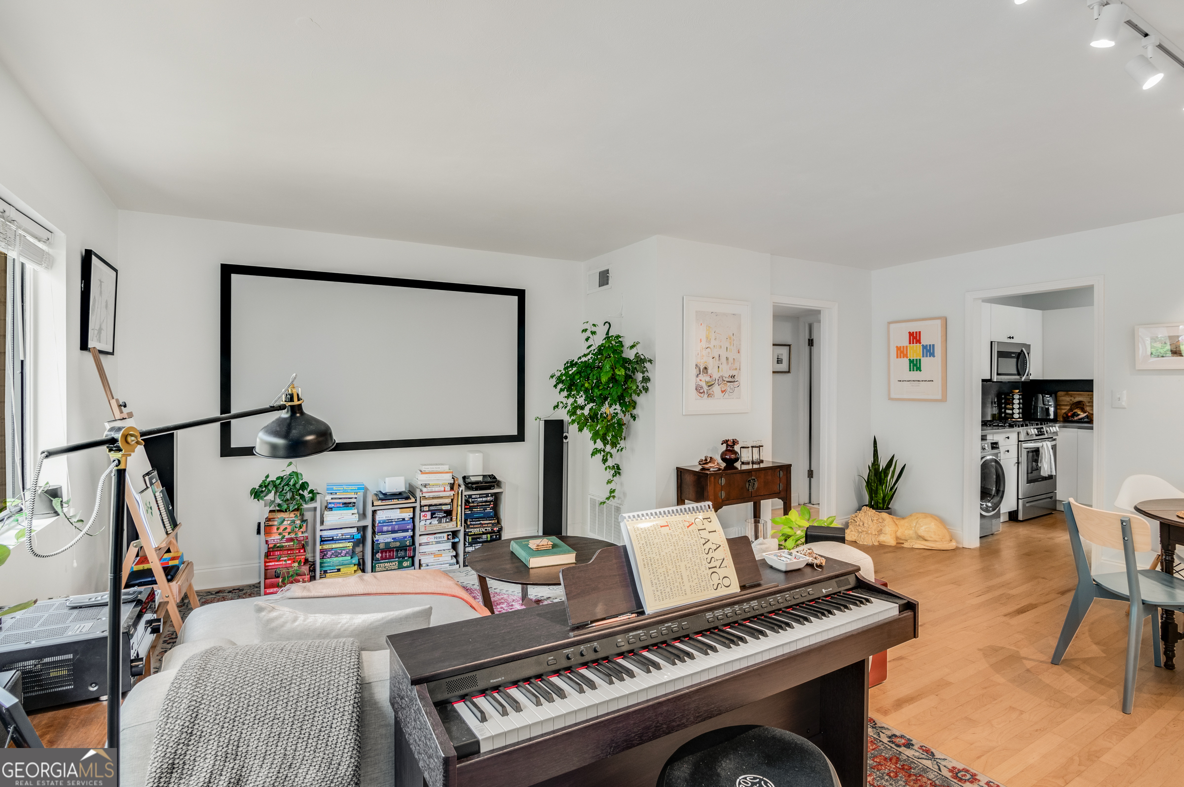 96 Ardmore Place Northwest, Unit 3 Atlanta, GA 30309 - Photo 3 of 24 a living room with furniture a rug and a flat screen tv
