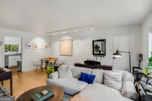 a living room with furniture and wooden floor