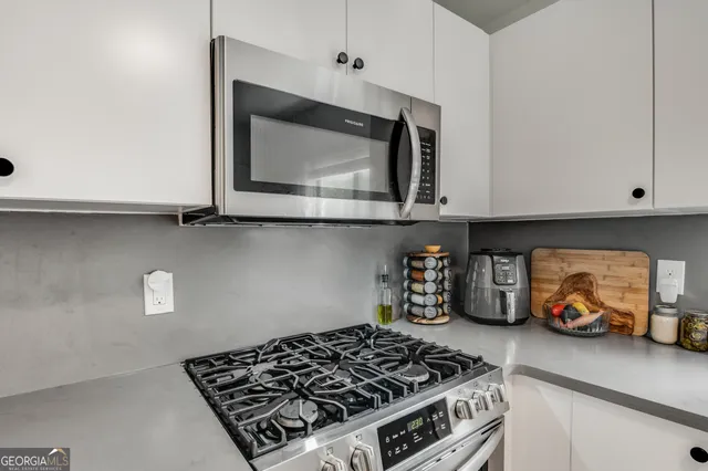 a kitchen with a stove and cabinets