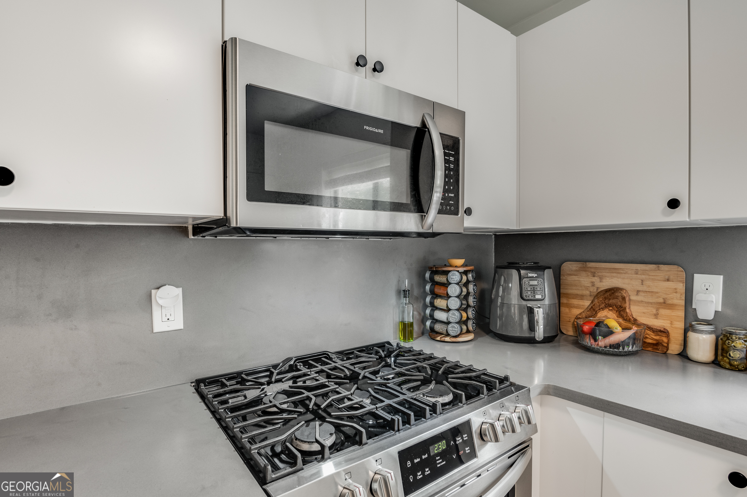 96 Ardmore Place Northwest, Unit 3 Atlanta, GA 30309 - Photo 9 of 24 a kitchen with a stove and cabinets