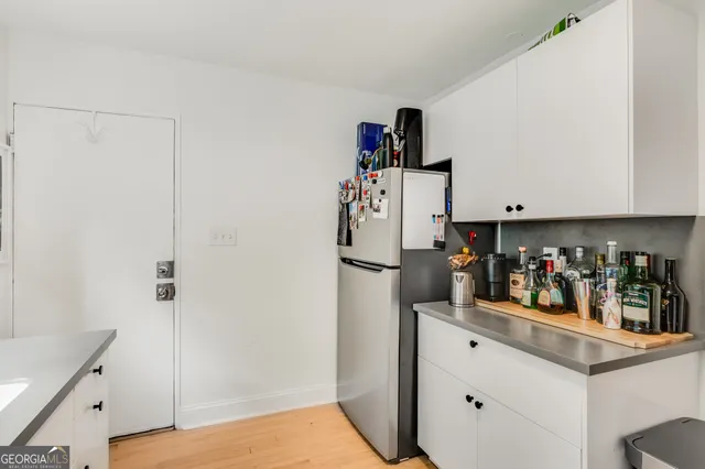 a view of a kitchen with fridge and closet