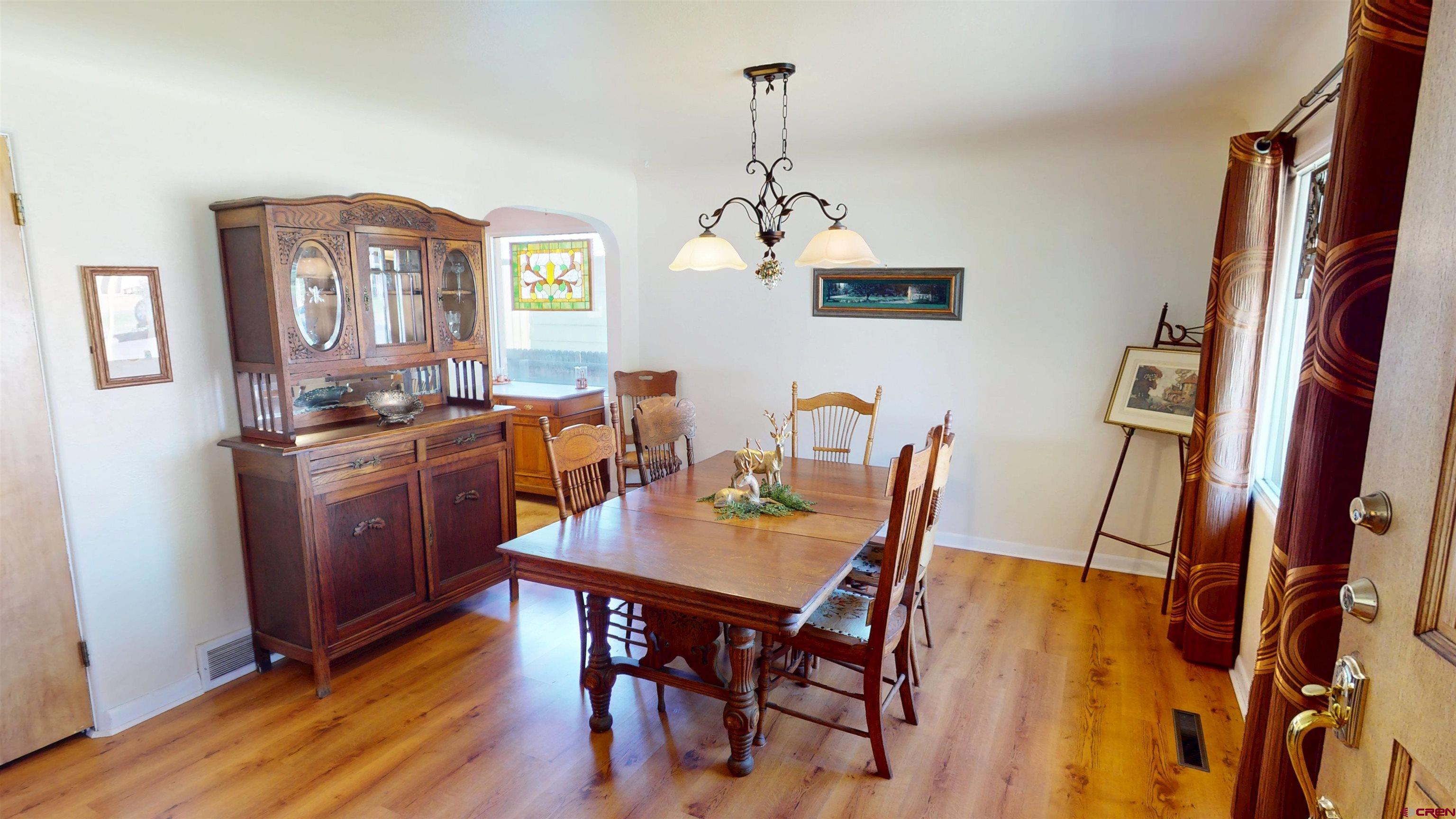 96 El Rio Drive Alamosa, CO 81101 - Photo 4 of 18 a view of a dining room with furniture window and wooden floor