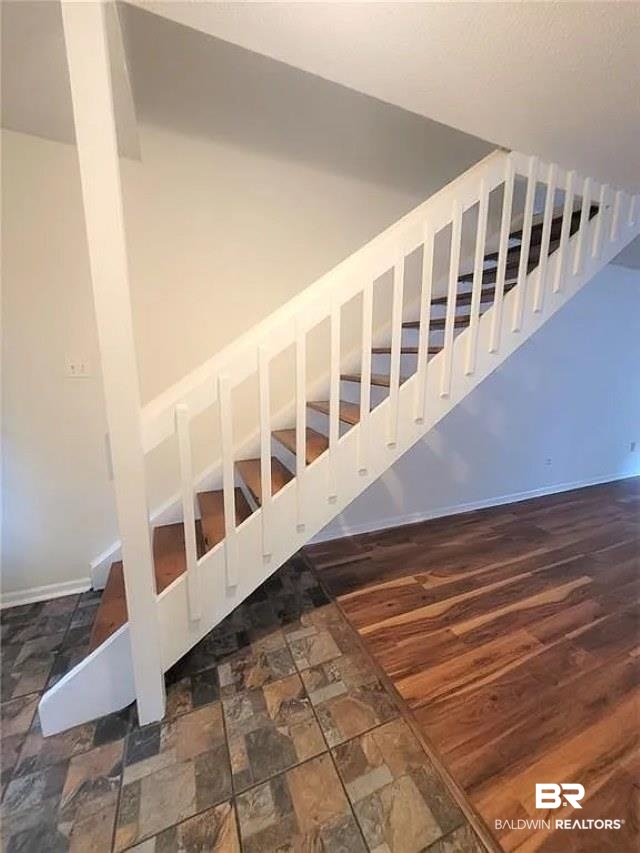 6701 Dickens Ferry Road, Unit 53 Mobile, AL 36608 - Photo 12 of 23 Stairway featuring baseboards and wood finished floors