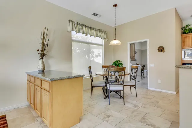 a view of a dining room with furniture and a chandelier