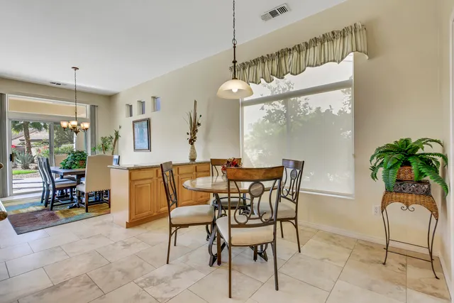 a view of a dining room with furniture and a potted plant