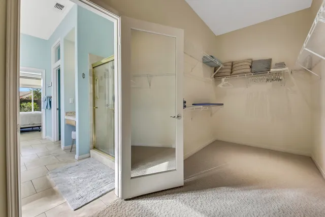 a living room with patio furniture and a garden