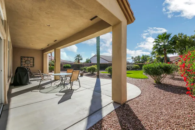 a view of a house with a backyard porch and sitting area