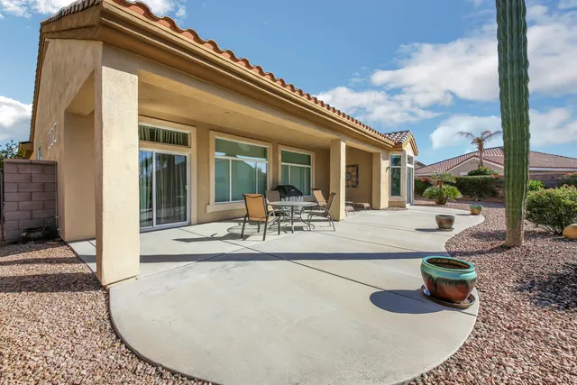 a front view of a house with garden and porch